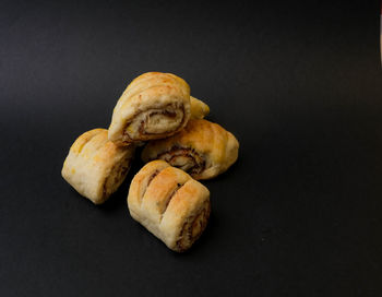 Close-up of bread on table against black background