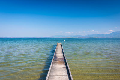 Scenic view of sea against blue sky