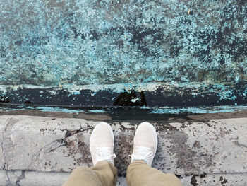 Low section of man standing on footpath