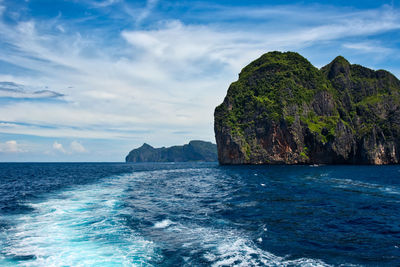 Rock formation in sea against sky