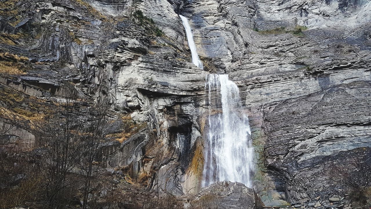 LOW ANGLE VIEW OF WATERFALL ON ROCK FORMATION