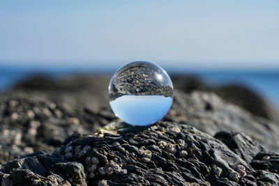 Close-up of crystal ball on rock