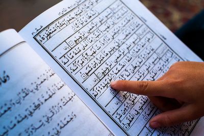 Close-up of hand writing on paper