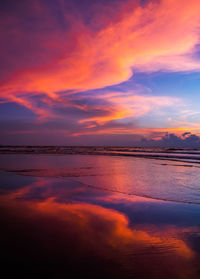 Scenic view of sea against dramatic sky during sunset