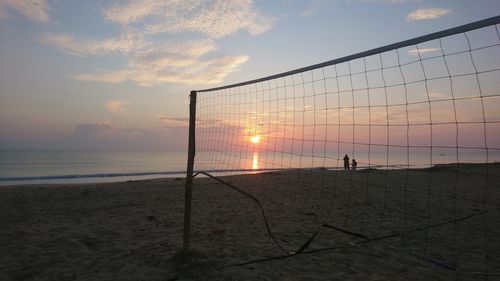 Scenic view of beach against sky during sunset