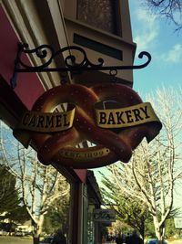 Low angle view of sign board against sky