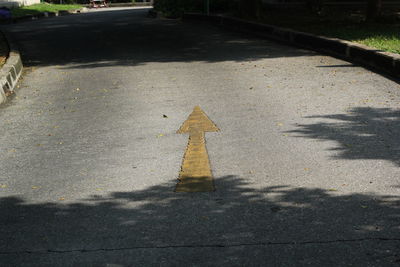 High angle view of arrow sign on road