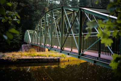Bridge over river against trees