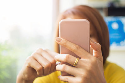 Close-up woman using phone in front of face