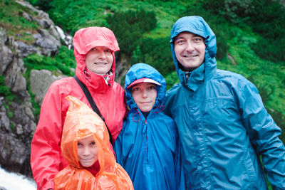 Portrait of family wearing raincoats during rainy season