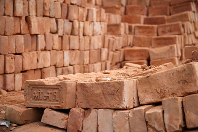 Close-up of stack of red bricks at construction site