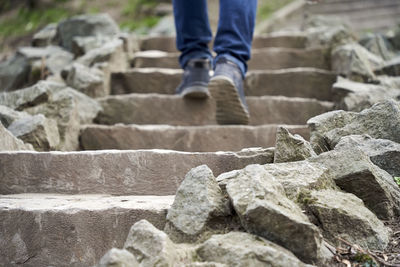 Low section of person standing on rock