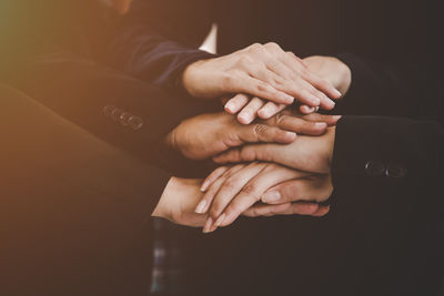 Close-up of business people stacking hands