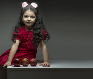 Portrait of young woman sitting on table