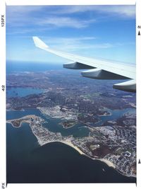Cropped image of airplane flying over cityscape
