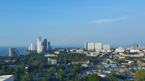 View of cityscape against cloudy sky