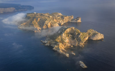 Aerial view of the medes islands in a foggy sunrise over the costa brava coast and mediterrania sea