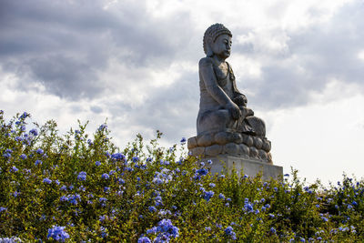 Low angle view of statue against cloudy sky