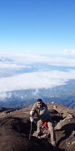 Man standing on mountain against sky