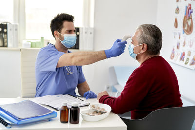 Female doctor examining patient in office