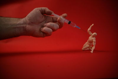 Close-up of hand holding syringe