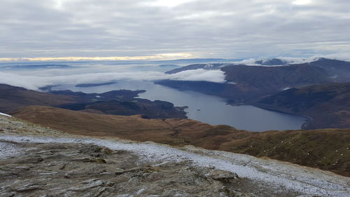 Scenic view of sea and mountains against sky