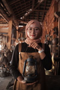 Portrait of a young woman holding drink