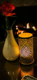 Close-up of illuminated tea light candles on table