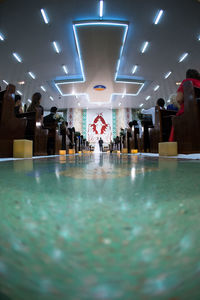 Group of people walking on tiled floor