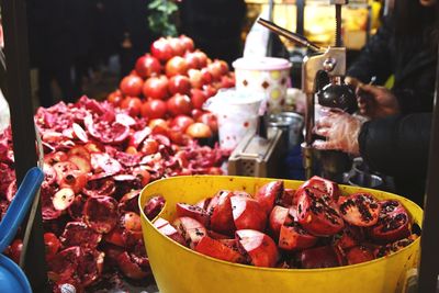 Midsection of men preparing food at market stall