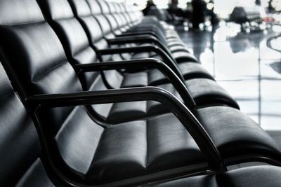 Close-up of chairs in row