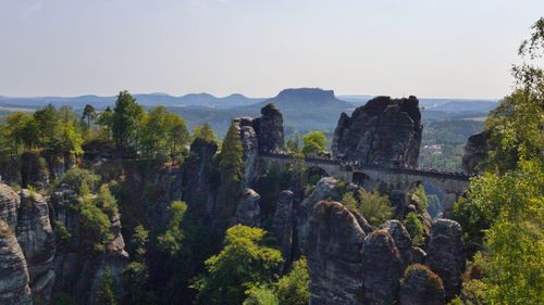 Panoramic view of trees and mountain against sky