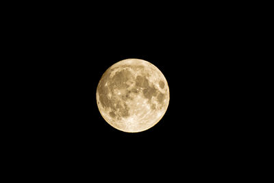 Low angle view of full moon against sky at night