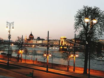 Illuminated bridge over river at night