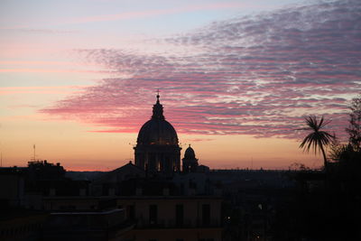 Silhouette of building against sky during sunset