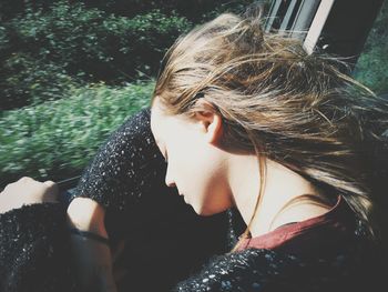 Close-up of girl sleeping while sitting in car