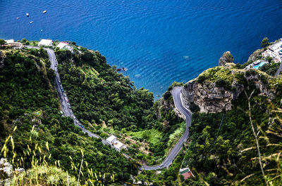 Directly above shot of mountain road by sea