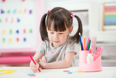 Young girl practice drawing different shapes for homeschooling