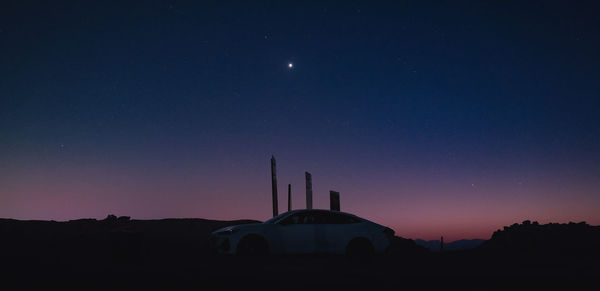 Low angle view of buildings against sky at night