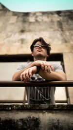 Portrait of senior man sitting on wall