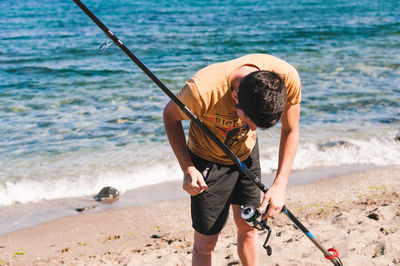 Full length of man fishing on beach