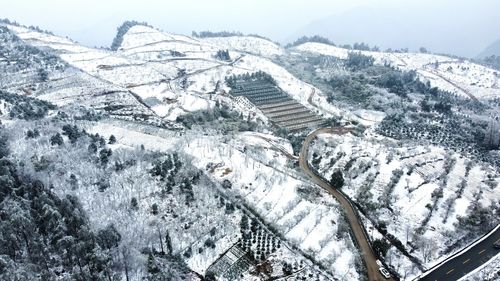 Aerial view of snow covered mountains against sky