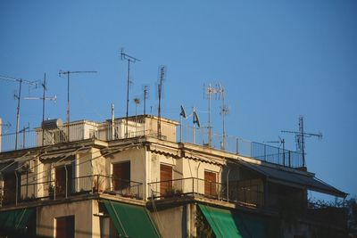 Low angle view of buildings against clear blue sky