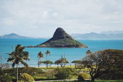 Scenic view of sea and mountains against sky