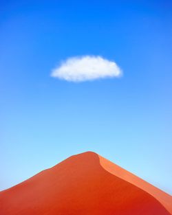 Low angle view of mountain against blue sky