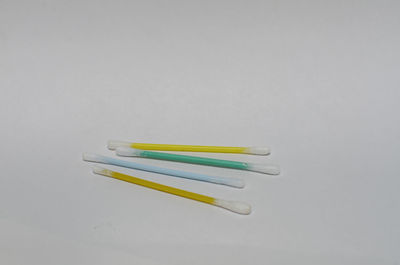 High angle view of colored pencils against white background