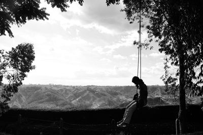 Person swinging on tree swing