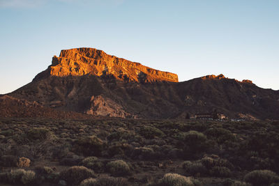 Rock formations on landscape against clear sky