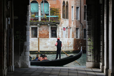 Men in boat against canal