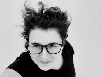 Close-up portrait of smiling woman standing at beach